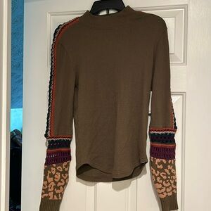 Greenish shirt with fun patterns on sleeves